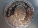 a close up of a coin with a pope on it