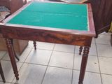 a table with a green cloth on it in a room