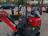 an image of a small excavator parked in a parking lot