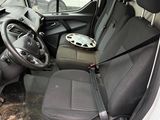 the interior of a small van with a steering wheel and a seat belt