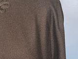 the back of a woman ' s sweater with a bow on it