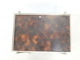 a picture of a tortoise shell case on a white surface