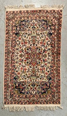 an antique persian rug with a floral design and fringes