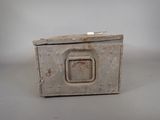 a small metal box with a handle on a table