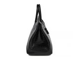 a black crocodile skin handbag on a white background