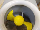 a yellow fan inside of a white toilet bowl