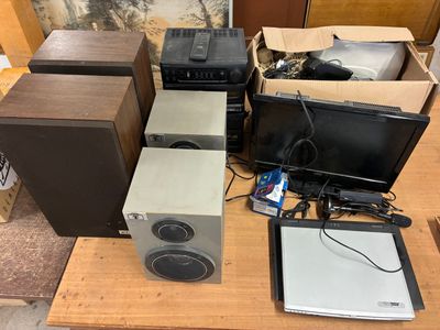 several speakers and a monitor sitting on a table