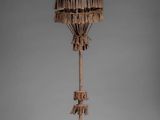an image of a wooden sculpture of a bird on a pole