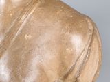 statue of a bust of a woman with a large breast