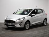 une Ford Fiesta blanche garée dans une pièce au sol à carreaux
