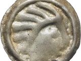 gros plan d'une pièce de monnaie sur laquelle figure un visage de femme