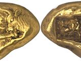 a close up of two gold coins on a white surface