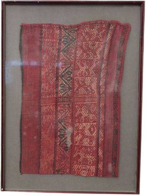 framed picture of a piece of cloth with a red and black design