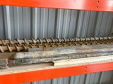 a close up of a metal rack with a bunch of wood on it