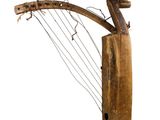 an old wooden musical instrument with a long neck and strings