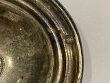 a close up of a silver plate on a table