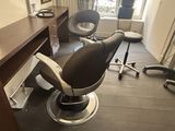 an image of a salon room with a chair and a desk