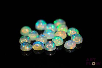 white fire oplite beads on a black background