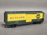 a green and yellow train car that is sitting on a table