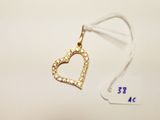 a small gold heart charm hanging from a white string