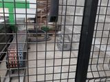 a metal fence that has a bunch of items in it