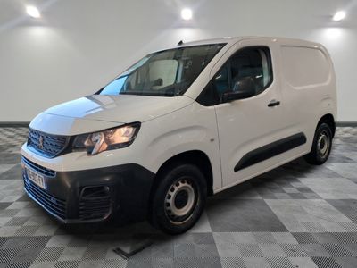 a white van parked on a checkered floor in a room