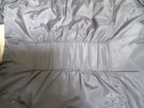 the back of a jacket with a belt on a wooden floor