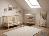 a baby ' s room with a crib and a bed in it