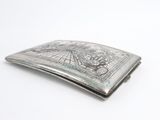 an old silver cigarette case with a picture of a man and a woman on it
