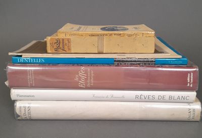 several books are stacked on top of each other on a table