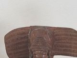 a statue of an elephant that is sitting on a table