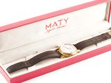 a watch that is in a box on a white surface