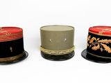three hats sitting next to each other on a white surface