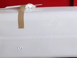 a white piece of luggage sitting on top of a red chair