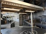 a kitchen with a stove, oven, and other appliances