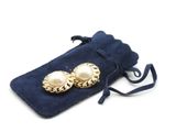 a close up of a pair of earrings on a bag