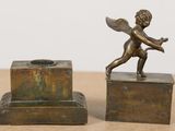 pair of antique bronze figurines of cupid playing with a flower
