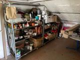a garage with a shelf full of pots and pans