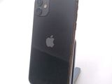 a black iphone sitting on a stand on a white surface