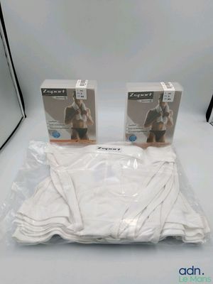 two boxes of white underwear sitting on top of a white table