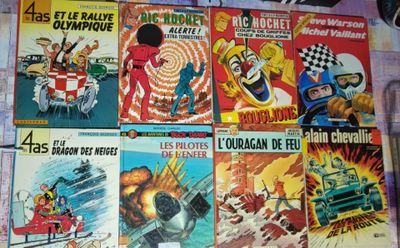 a lot of comic books on the table together