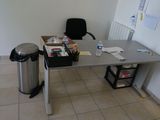 a desk with a trash can and a trash can on it