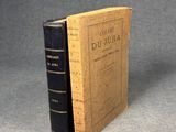 an old book sitting on top of a table next to a book