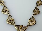 an image of a gold necklace on a white background