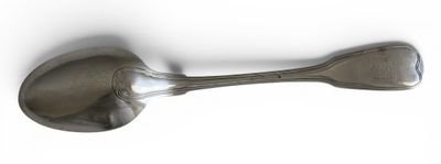 a spoon and a spoon rest on a white surface