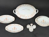 an image of a group of porcelain dishes on a black surface