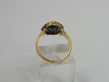 a close up of a gold ring with a blue stone on it