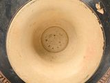 a vase that has a black and brown design on it