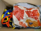 a cardboard box filled with many different types of clothing