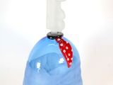 a blue vase with a statue on top of it